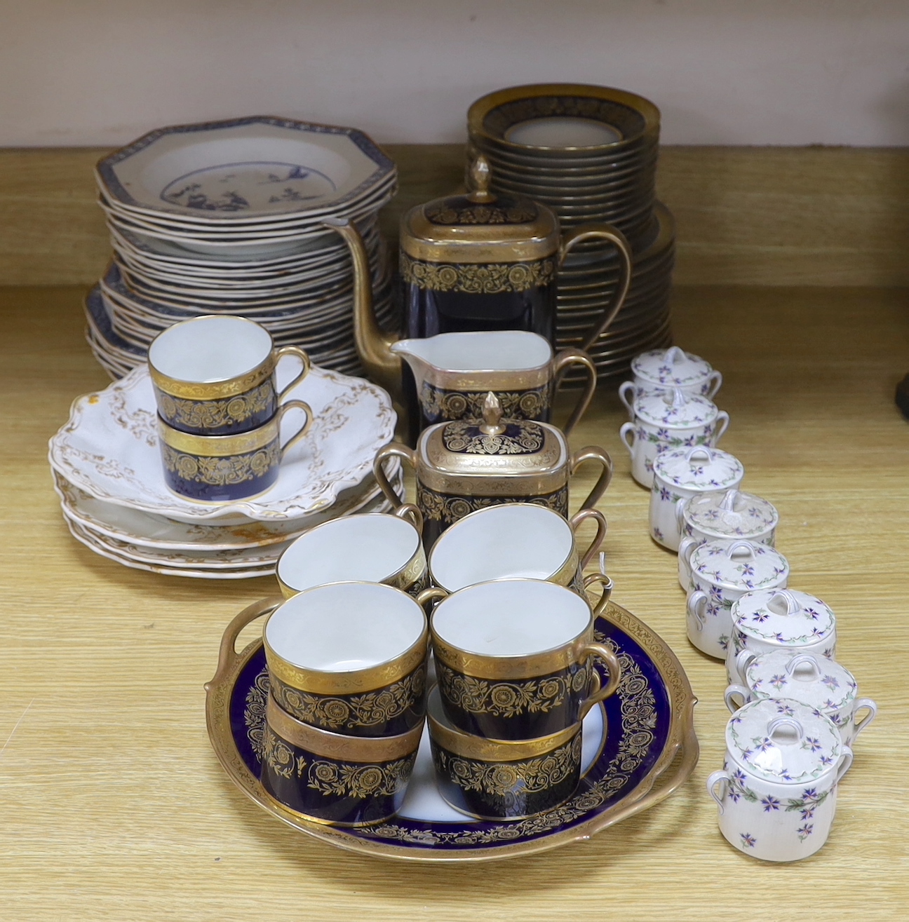 A Raynaud and Co. Limoges gilt and navy ten cup coffee service, a Woodsware part dinner service and eight Limoges floral pots and covers